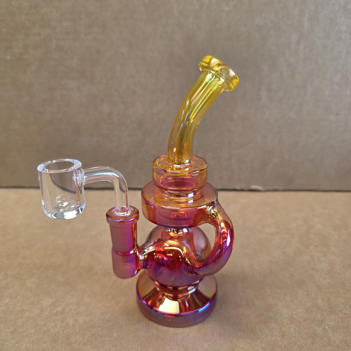 Side profile view of colorful dab rig water pipe ready for concentrate use