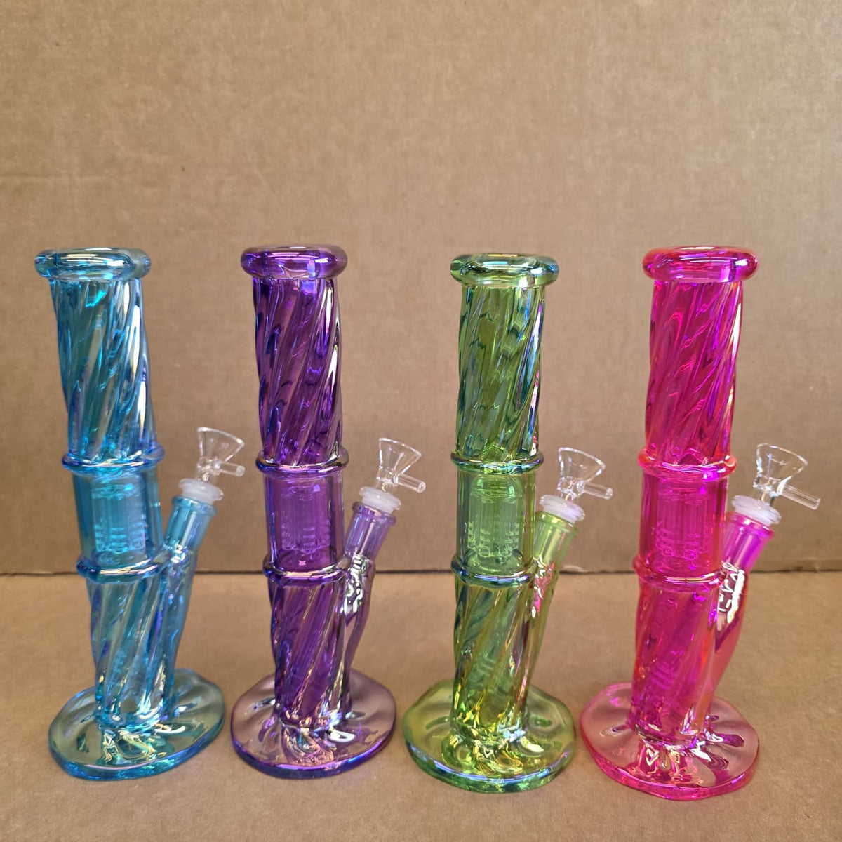 Angled perspective showing colored glass rim on straight neck mouthpiece and clear cylinder chamber