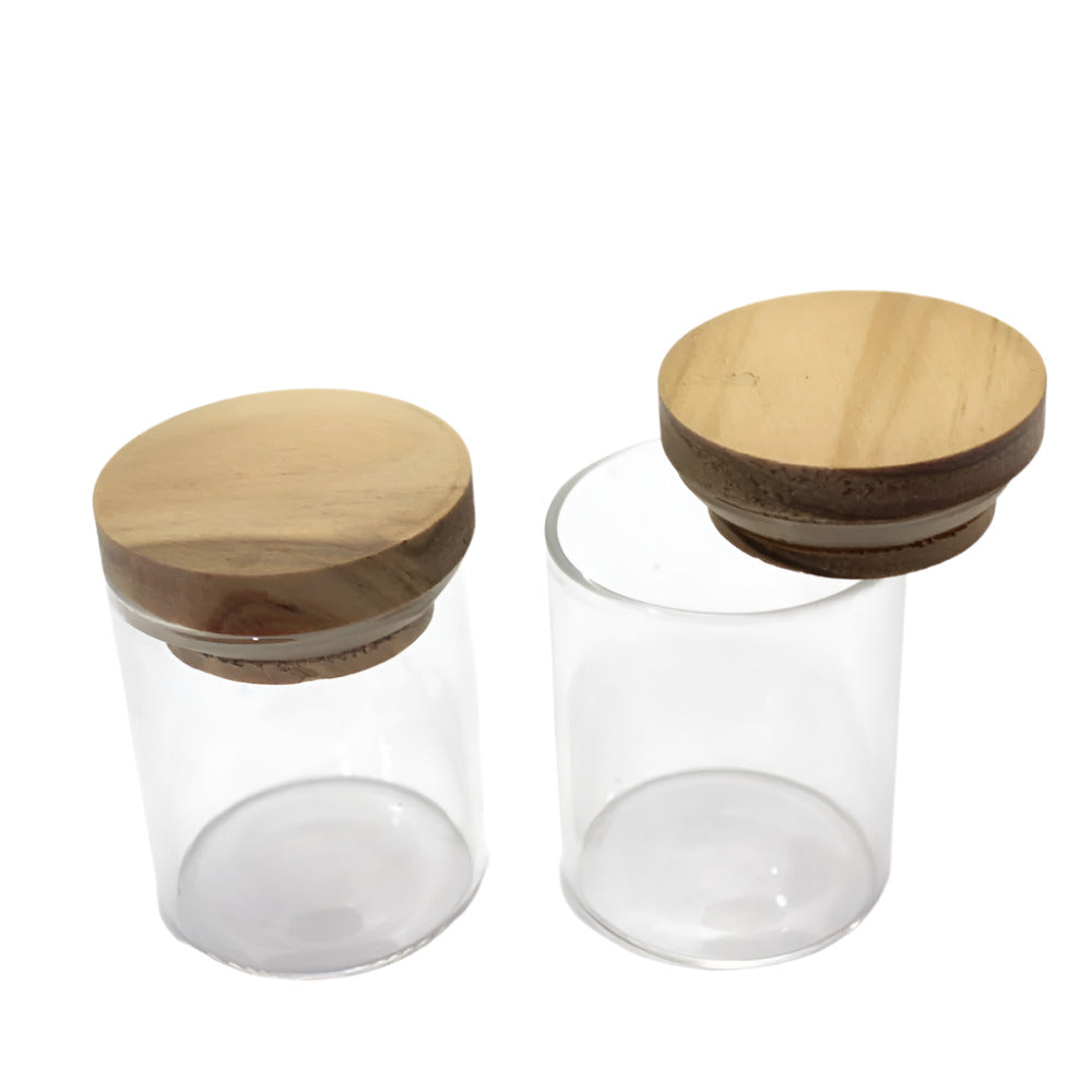Small glass jar with wooden lid featuring durable clear glass construction, secure closure, and compact stylish storage design.