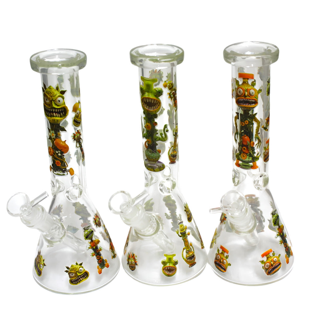 Glow in the dark beaker water pipe with monster decal design, 14mm male bowl, durable glass construction, and stable base.