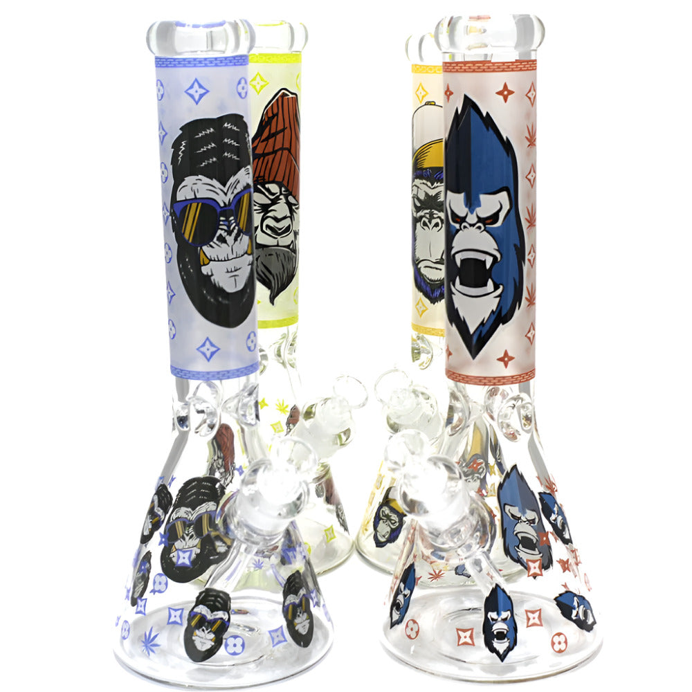 Heavy beaker water pipe with glow-in-the-dark decal art design, glass-on-glass connection, and durable thick glass construction.