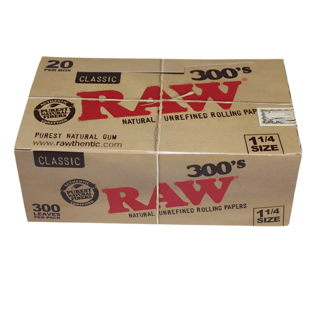 RAW Classic 300’s 1¼ Size pre-rolled cones featuring 20 per box made from natural unbleached paper for a smooth, slow, and even burn experience.