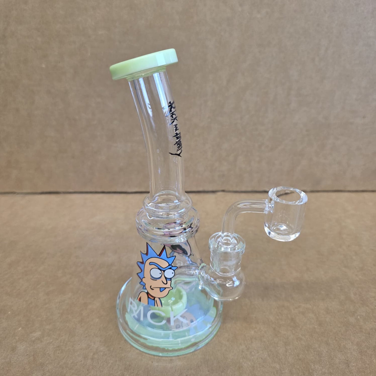 Full view of RM decal tube color dab rig water pipe fitted with 14mm male quartz banger