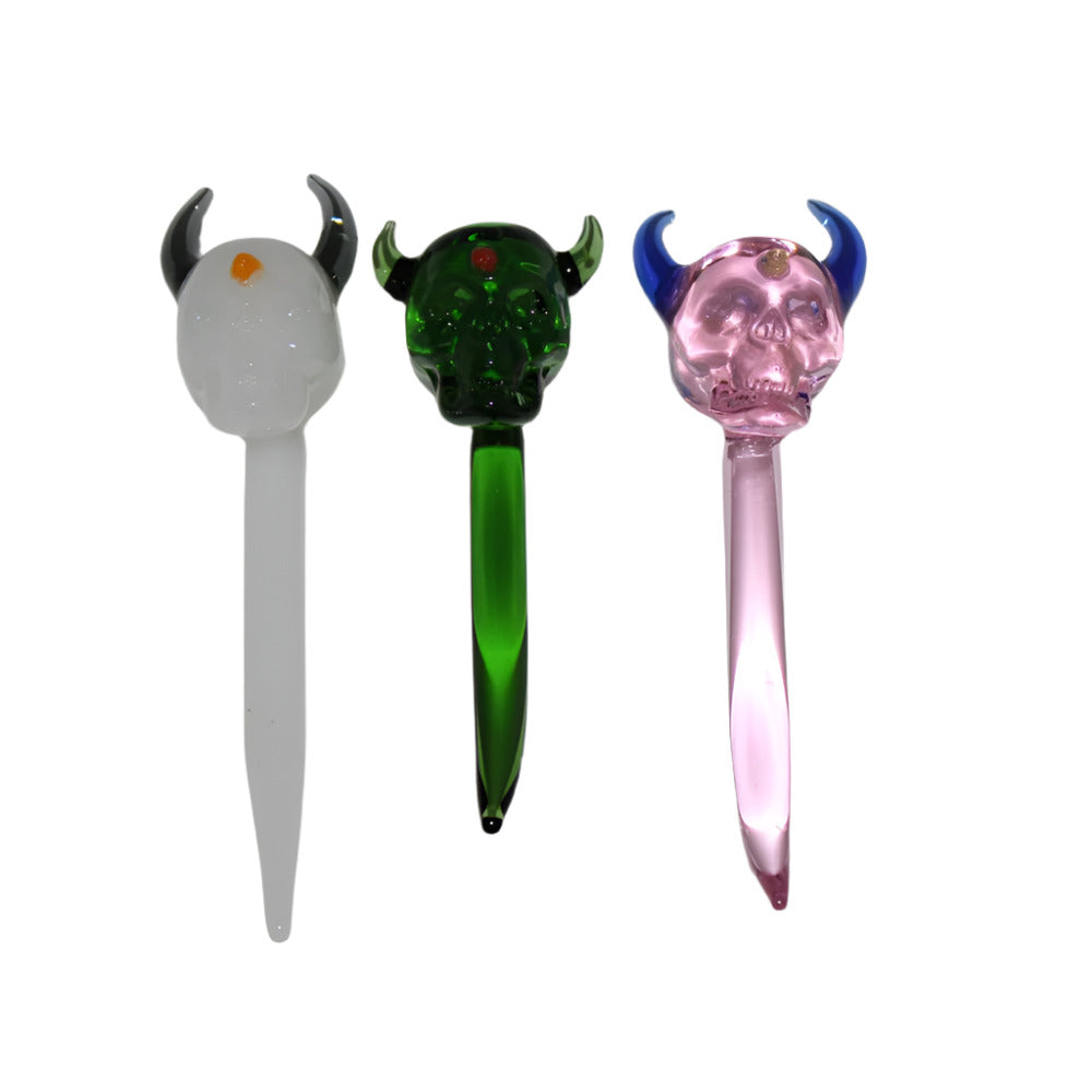 Skull design glass dab tool made from durable heat resistant glass with bold artistic skull shape compact stylish and easy for precise use